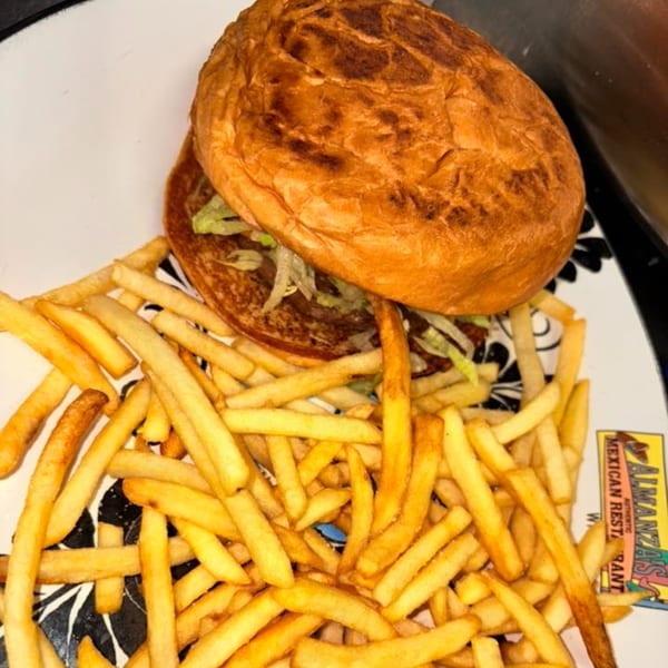Almanza's Mexican Restaurant burger with shredded lettuce and a side of golden french fries.