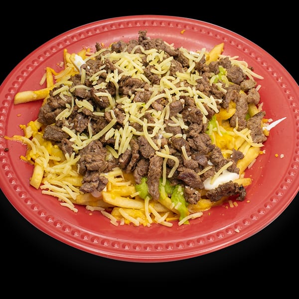 Almanza's carne asada fries, topped with shredded cheese, sour cream, and green peppers.